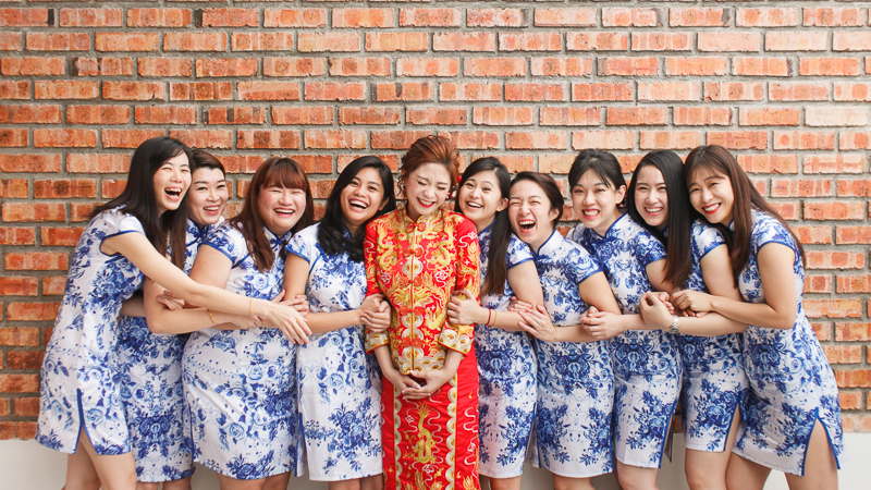 Happy bride with bridesmaids in cheongsam